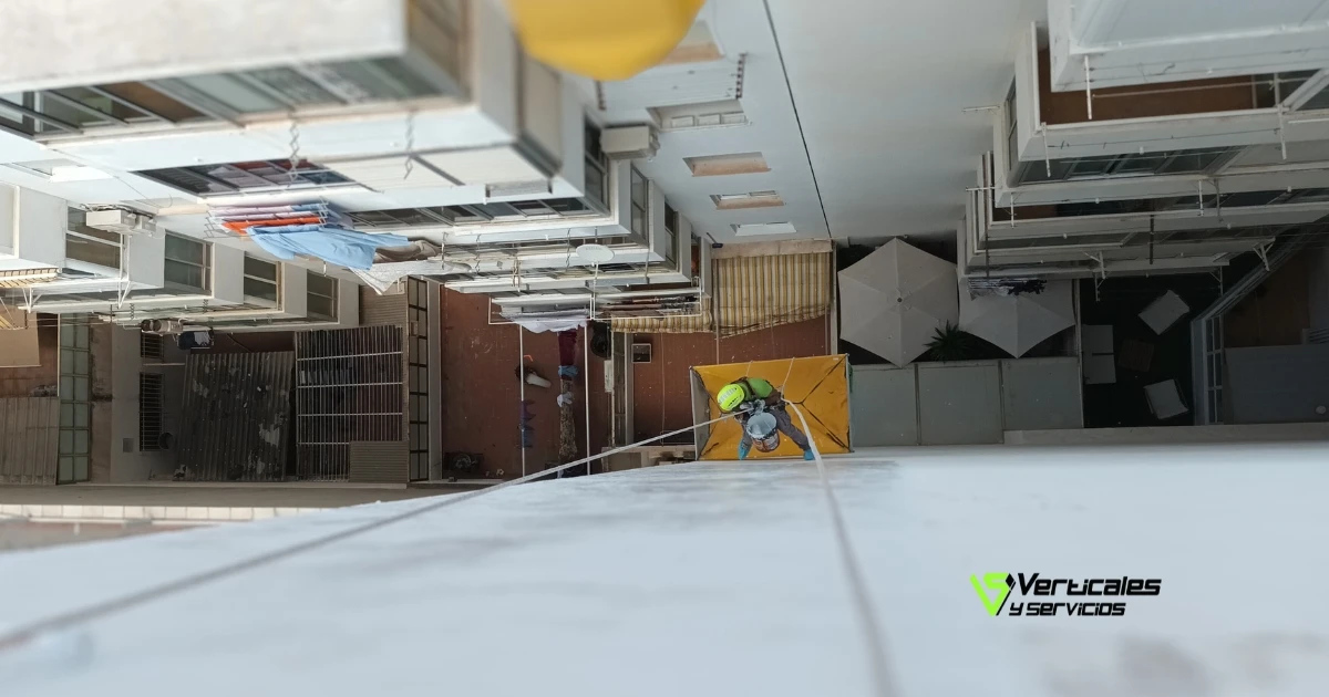 Operario de Verticales y Servicios operando en una fachada vertical para demostrar cómo impermeabilizar fachadas.